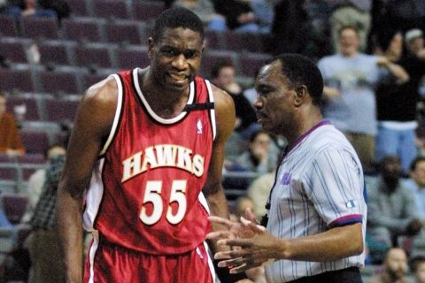 Atlanta Hawks' Dikembe Mutombo complains to referee Hue Hollins in the fourth quarter Wednesday, Dec. 13, 2000, in Auburn Hills, Mich. Mutombo was held scoreless in the game and pulled in just six rebounds in their 92-69 loss. (AP Photo/Duane Burleson)