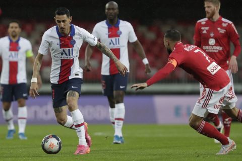 PSG's Angel Di Maria, left, is challenged by Brest's Haris Belkebla, right, during the French League One soccer match between Brest and Paris Saint-Germain at the Stade Francis-Le Ble stadium in Brest, France, Sunday, May 23, 2021. (AP Photo/Thibault Camus)