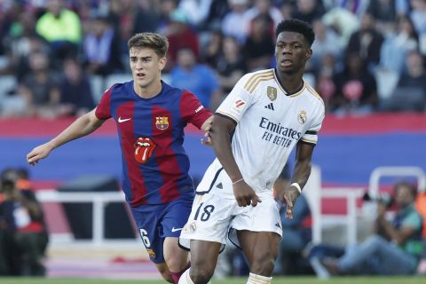 Barcelona's Gavi, left, and Real Madrid's Aurelien Tchouameni in action during the La Liga soccer match between Barcelona and Real Madrid at the Olympic Stadium in Barcelona, Spain, Saturday, Oct. 28, 2023. (AP Photo/Joan Monfort)