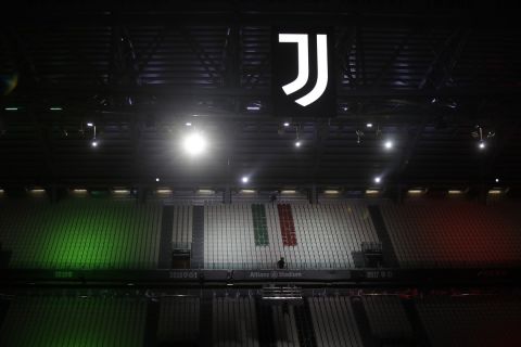 The colors of the Italian flag colored the empty fans seats of the Allianz stadium end of a Serie A soccer match between Juventus and Roma, at the Allianz stadium in Turin, Italy, Saturday, Aug.1, 2020. (AP Photo/Luca Bruno)