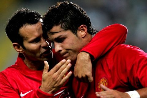 Manchester United's Cristiano Ronaldo, a former Sporting player, celebrates with teammate Ryan Giggs, left, after scoring a goal during their Champions League group F soccer match Wednesday, Sept. 19 2007, at the Alvalade stadium in Lisbon, Portugal. Manchester United defeated Sporting 1-0. (AP Photo/Octavio Passos)