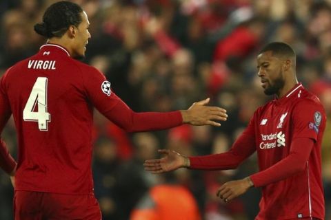 Liverpool's Georginio Wijnaldum celebrates scoring his side's 2nd goal with Virgil Van Dijk during the Champions League semifinal, second leg, soccer match between Liverpool and FC Barcelona at the Anfield stadium in Liverpool, England, Tuesday, May 7, 2019. (AP Photo/Dave Thompson)