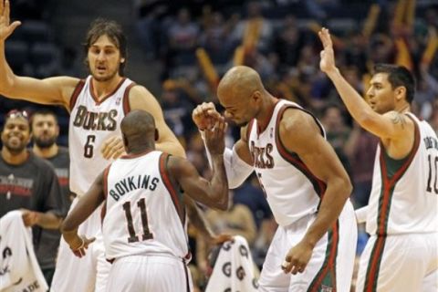 Milwaukee Bucks' Andrew Bogut (6), Earl Boykins (11), Corey Maggette, second from right, and Carlos Delfino, right, react against the Atlanta Hawks in the second half of an NBA basketball game Wednesday, Jan. 26, 2011, in Milwaukee. The Bucks won 98-90. (AP Photo/Jeffrey Phelps)