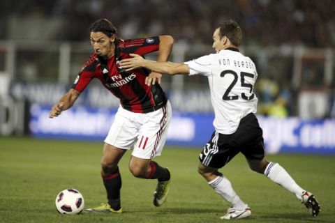 AC Milan's Zlatan Ibrahimovic (L) fights for the ball with Cesena's Steve von Bergen during their Italian Serie A soccer match at the Dino Manuzzi stadium in Cesena September 11, 2010.  REUTERS/Marco Bucco (ITALY - Tags: SPORT SOCCER)