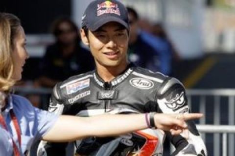 Championship leader Hiroshi Aoyama, from Japan, smiles Saturday, Oct. 3 2009, after clocking the fourth best time in the 250cc qualifying session for Sunday's Portugal Grand Prix at the Estoril racetrack in Sintra, outside Lisbon. (AP Photo/Armando Franca)