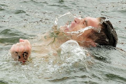 Spyros Gianniotis of Greece celebrates after crossing the finish line to win the men's 10km open water swimming event of the FINA World Championships at Jinshan Beach in Shanghai on July 20, 2011.  AFP PHOTO / MARK RALSTON (Photo credit should read MARK RALSTON/AFP/Getty Images)