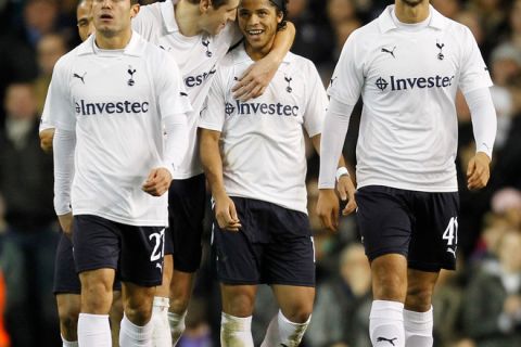 Tottenham Hotspur's Mexican striker Giovani dos Santos (2nd R) celebrates scoring his goal with English defender Michael Dawson (2nd L) during the English FA Cup 3rd Round football match between Tottenham Hotspur and Cheltenham Town at White Hart Lane in north London, England on January 7, 2012. AFP PHOTO/IAN KINGTON

RESTRICTED TO EDITORIAL USE. No use with unauthorized audio, video, data, fixture lists, club/league logos or live services. Online in-match use limited to 45 images, no video emulation. No use in betting, games or single club/league/player publications (Photo credit should read IAN KINGTON/AFP/Getty Images)