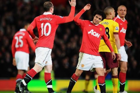 MANCHESTER, ENGLAND - MARCH 12:  Wayne Rooney of Manchester United celebrates scoring his side's second gaol with teammate Rafael Da Silva during the FA Cup sponsored by E.On Sixth Round match between Manchester United and Arsenal at Old Trafford on March 12, 2011 in Manchester, England.  (Photo by Clive Mason/Getty Images)