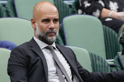 Football manager Pep Guardiola watches the third round match between Cameron Norrie of Britain and Alexander Zverev of Germany at the Wimbledon tennis championships in London, Saturday, July 6, 2024. (AP Photo/Kirsty Wigglesworth)