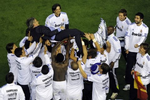 Real Madrid players toss Real Madrid's Portuguese coach Jose Mourinho after winning the Spanish Cup final match Real Madrid against Barcelona at the Mestalla stadium in Valencia on April 20, 2011.  Real Madrid won 1-0.  AFP PHOTO/ PEDRO ARMESTRE (Photo credit should read PEDRO ARMESTRE/AFP/Getty Images)