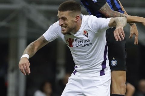 Inter Milan's Matias Vecino jumps over Fiorentina's Cristiano Biraghi during the Serie A soccer match between Inter Milan and Fiorentina, at the San Siro stadium in Milan, Italy, Tuesday, Sept. 25, 2018. (AP Photo/Luca Bruno)