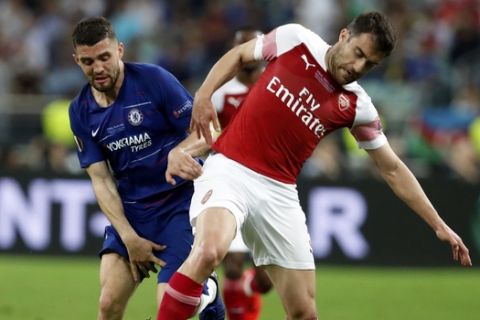 Chelsea's Mateo Kovacic fights for the ball with Arsenal's Sokratis Papastathopoulos, right, during the Europa League Final soccer match between Chelsea and Arsenal at the Olympic stadium in Baku, Azerbaijan, Wednesday, May 29, 2019. (AP Photo/Darko Bandic)