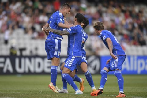 Italy's Lorenzo Pirola, left, celebrates after scoring his side's first goal, during the Euro 2023 U21 Championship soccer match between Switzerland and Italy at the Cluj Arena stadium in Cluj, Romania, Sunday, June 25, 2023.(AP Photo/Raed Krishan)