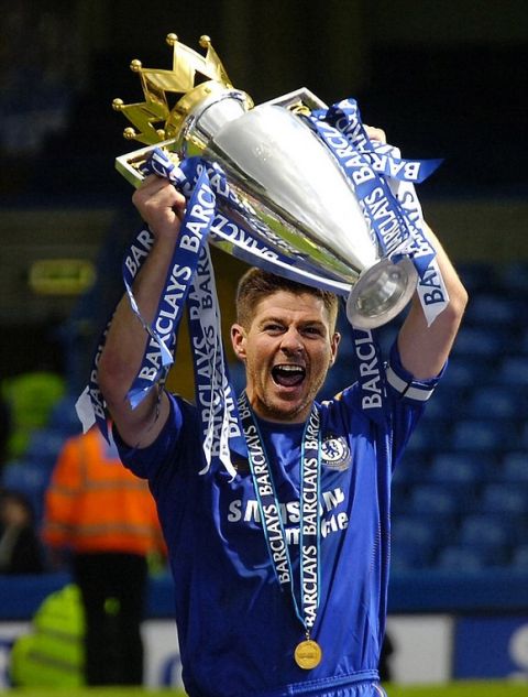 Chelsea's John Terry gets his hands on the trophy to celebrate winning the  Premiership at Stamford Bridge. Football: Barclays Premiership: Chelsea v Manchester United (3-0)
. REXMAILPIX.