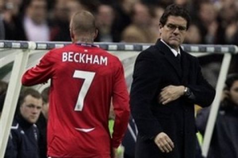 England's soccer coach Fabio Capello, right, looks on as David Beckham leaves the field during their friendly soccer match against France at Stade de France stadium in Saint Denis, outskirts of Paris, Wednesday, March 26, 2008. (AP Photo/Francois Mori)