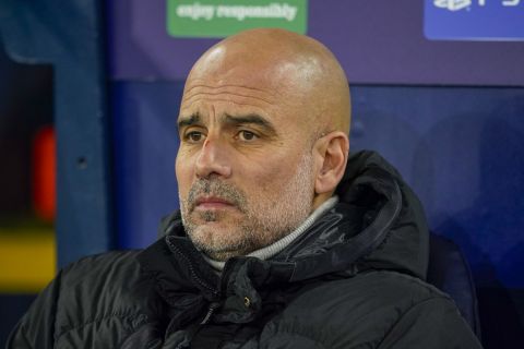 Manchester City's head coach Pep Guardiola takes his seat on the bench before the Champions League opening phase soccer match between Manchester City and Feyenoord at the Etihad Stadium in Manchester, England, Tuesday, Nov. 26, 2024. (AP Photo/Dave Thompson)