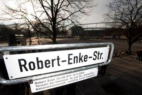 The sign of the "Robert-Enke-Strasse" is seen in front of the football stadium in Hanover, northern Germany, Monday, Jan 17, 2011. Hanover has inaugurated a Robert Enke Street, 14 months after the Germany goalkeeper's suicide.  The new Robert-Enke-Strasse is close to the stadium of Enke's club, Hanover. Enke, who was Hanover's captain, suffered from depression and ended his life by stepping in front of a train on Nov. 10, 2009. He was 32.  (AP Photo/dapd, Stefan Simonsen)