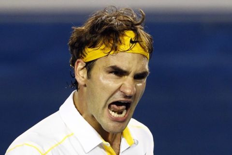 Roger Federer of Switzerland reacts after winning against Gilles Simon of France at the Australian Open tennis tournament in Melbourne January 19, 2011.                    REUTERS/David Gray (AUSTRALIA  - Tags: SPORT TENNIS IMAGE OF THE DAY TOP PICTURE)