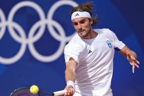 Stefanos Tsitsipas of Greece hits a forehand shot to Zizou Bergs of Belgium during the men's singles tennis competition, at the 2024 Summer Olympics, Sunday, July 28, 2024, in Paris, France. (AP Photo/Andy Wong)