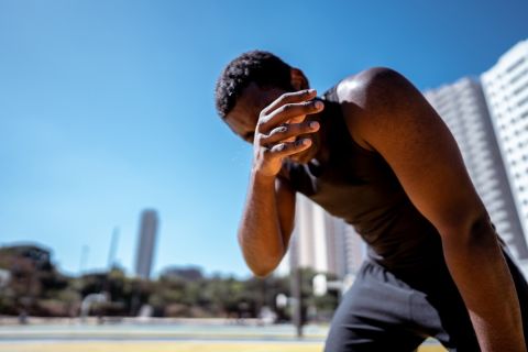 Tired young man during exercises outdoors