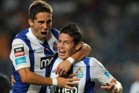 FC Porto's James Rodriguez, right, from Colombia, celebrates with Joao Moutinho after scoring his team second goal against Academica in a Portuguese League soccer match at the Municipal Stadium in Coimbra, Portugal, Sunday, Oct. 2, 2011. (AP Photo/Paulo Duarte)