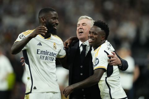 Real Madrid's head coach Carlo Ancelotti, centre, celebrates with his players Vinicius Junior, right, and Antonio Rudiger after winning the Champions League semifinal second leg soccer match between Real Madrid and Bayern Munich at the Santiago Bernabeu stadium in Madrid, Spain, Wednesday, May 8, 2024. Real Madrid won 2-1. (AP Photo/Jose Breton)