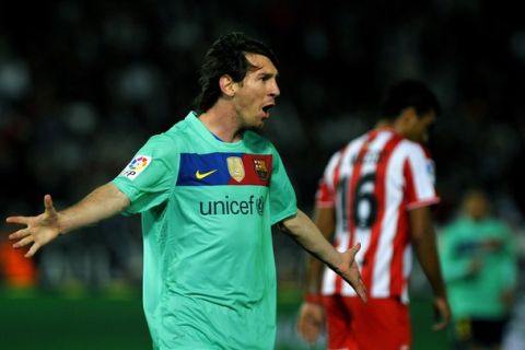 Barcelona's Argentinian forward Lionel Messi celebrates after scoring against Almeria during their Liga football match U.D. Almeria vs F.C Barcelona at Juegos del Mediterraneo stadium in Almeria on November 20, 2010. AFP PHOTO / JORGE GUERRERO. (Photo credit should read Jorge Guerrero/AFP/Getty Images)