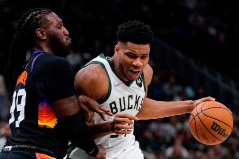 Milwaukee Bucks' Giannis Antetokounmpo tries to get past Phoenix Suns' Jae Crowder during the first half of an NBA basketball game Sunday, March 6, 2022, in Milwaukee . (AP Photo/Morry Gash)