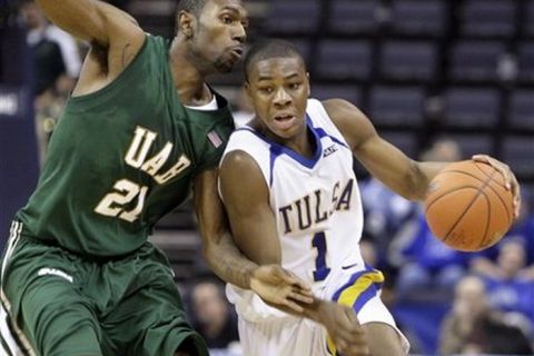 Tulsa guard Ben Uzoh (1) tries to get past UAB forward Lawrence Kinnard (21) in the second half of an NCAA college basketball game at the Conference USA men's tournament in Memphis, Tenn., Friday, March 13, 2009. Tulsa won 70-67 and will face Memphis in the championship game Saturday. (AP Photo/Mark Humphrey)