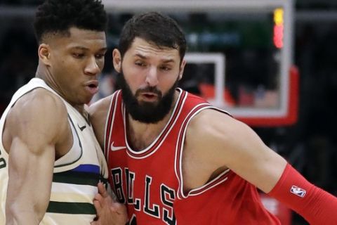 Chicago Bulls forward Nikola Mirotic, right, drives against Milwaukee Bucks forward Giannis Antetokounmpo during the second half of an NBA basketball game Sunday, Jan. 28, 2018, in Chicago. (AP Photo/Nam Y. Huh)