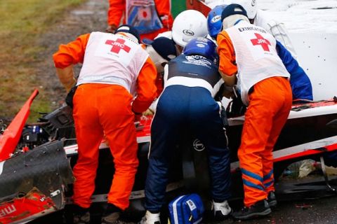 SUZUKA, JAPAN - OCTOBER 05:  Jules Bianchi of France and Marussia receives urgent medical treatment after crashing during the Japanese Formula One Grand Prix at Suzuka Circuit on October 5, 2014 in Suzuka, Japan.  (Photo by Getty Images/Getty Images)