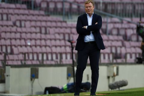 Barcelona's head coach Ronald Koeman watches the game during the Spanish La Liga soccer match between FC Barcelona and Celta at the Camp Nou stadium in Barcelona, Spain, Sunday, May. 16, 2021. (AP Photo/Joan Monfort)