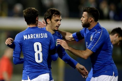 Italys Manolo Gabbiadini, center,  celebrates with his teammates Claudio Marchisio, left, and Andrea Barzagli  after scoring during a friendly soccer match between Italy and Romania at the Renato Dall'Ara stadium in Bologna, Italy, Tuesday, Nov. 17, 2015. (AP Photo/Luca Bruno)