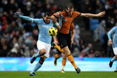 MANCHESTER, UNITED KINGDOM - JANUARY 15:   Christophe Berra of Wolverhampton Wanderers battles for the ball with Carlos Tevez of Manchester City during the Barclays Premier League match between Manchester City and Wolverhampton Wanderers at the City of Manchester Stadium on January 15, 2011 in Manchester, England. (Photo by Alex Livesey/Getty Images)