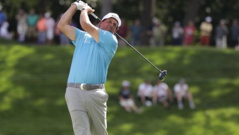 Phil Mickelson watches his tee shot on the 18th hole during the second round of the BMW Championship golf tournament at Medinah Country Club, Friday, Aug. 16, 2019, in Medinah, Ill. (AP Photo/Nam Y. Huh)