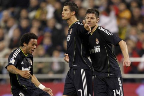 ZARAGOZA, SPAIN - DECEMBER 12:  Cristiano Ronaldo (C) of Real Madrid celebrates with his team mates Xabi Alonso (R) and Marcelo VIeira after scoring Real's second goal during the La Liga match between Real Zaragoza and Real Madrid at La Romareda stadium on December 12, 2010 in Zaragoza, Spain.  (Photo by Angel Martinez/Getty Images)