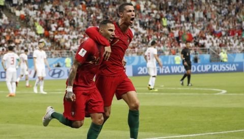 Portugal's Ricardo Quaresma, left, celebrates scoring his team's opening goal along with teammate Portugal's Cristiano Ronaldo during the group B match between Iran and Portugal at the 2018 soccer World Cup at the Mordovia Arena in Saransk, Russia, Monday, June 25, 2018. (AP Photo/Pavel Golovkin)