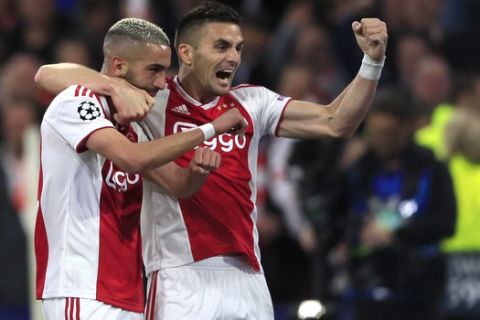 Ajax's Hakim Ziyech celebrates with Dusan Tadic, right,after scoring his side's second goal during the Champions League semifinal second leg soccer match between Ajax and Tottenham Hotspur at the Johan Cruyff ArenA in Amsterdam, Netherlands, Wednesday, May 8, 2019. (AP Photo/Peter Dejong)