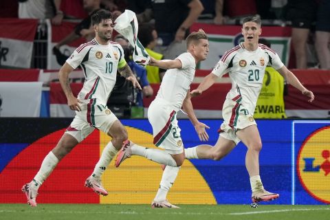 Hungary's Kevin Csoboth, center, celebrates after scoring the opening goal during a Group A match between Scotland and Hungary at the Euro 2024 soccer tournament in Stuttgart, Germany, Sunday, June 23, 2024. (AP Photo/Matthias Schrader)