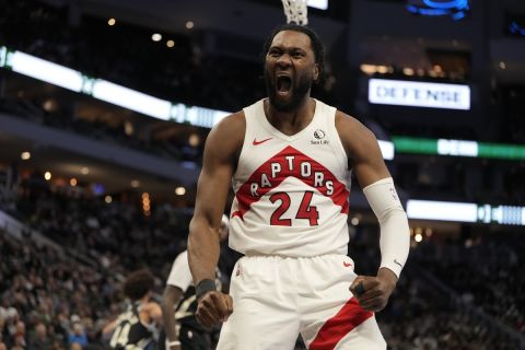 Toronto Raptors' Bruno Fernando reacts after a dunks during the second half of an Emirates NBA Cup tournament basketball game against the Milwaukee Bucks Tuesday, Nov. 12, 2024, in Milwaukee. (AP Photo/Morry Gash)