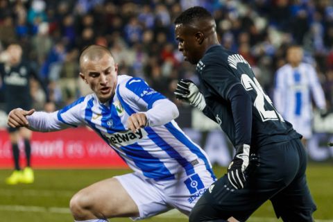 Real Madrid's Vinicius, center, heads for the ball with Leganes' Vasyl Kravets during a Spanish Copa del Rey soccer match between Leganes and Real Madrid at the Butarque stadium in Leganes, Spain, Wednesday, Jan. 16, 2019. (AP Photo/Valentina Angela)