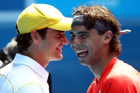 MELBOURNE, AUSTRALIA - JANUARY 16:  Rafael Nadal of Spain and Roger Federer enjoy the day during the "Rally For Relief" charity exhibition match ahead of the 2011 Australian Open at Melbourne Park on January 16, 2011 in Melbourne, Australia.  (Photo by Julian Finney/Getty Images)
