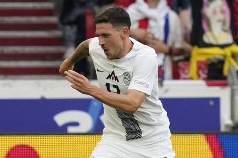 Slovenia's Erik Janza celebrates scoring his side's first goal during a Group C match between Slovenia and Denmark at the Euro 2024 soccer tournament in Stuttgart, Germany, Sunday, June 16, 2024. (AP Photo/Antonio Calanni)