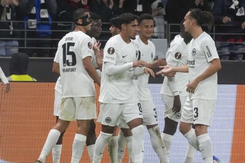 Frankfurt's Rasmus Kristensen, left, celebrates after scoring his side's third goal during the Europa League soccer match between Eintracht Frankfurt and Viktoria Plzen in Frankfurt, Germany, Thursday, Sept. 26, 2024. (AP Photo/Michael Probst)