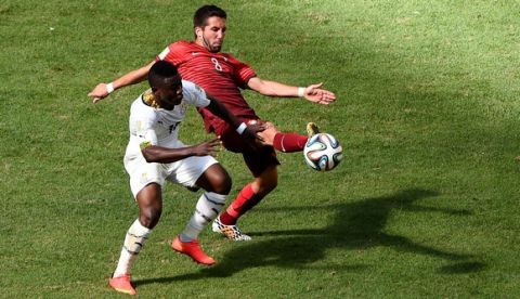 BRASILIA, BRAZIL - JUNE 26:  Majeed Waris of Ghana  and Joao Moutinho of Portugal compete for the ball during the 2014 FIFA World Cup Brazil Group G match between Portugal and Ghana at Estadio Nacional on June 26, 2014 in Brasilia, Brazil.  (Photo by Christopher Lee/Getty Images)