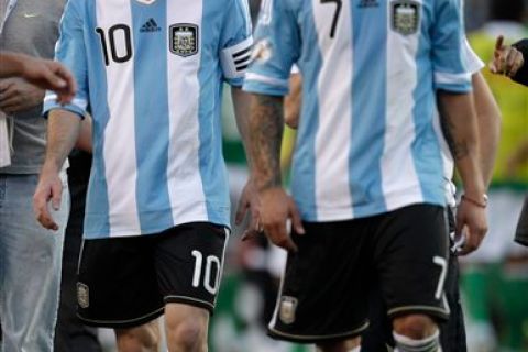 Argentina's Lionel Messi and Ezequiel Lavezzi leave the field after a 1-1 tie with Bolivia during a World Cup 2014 qualifying soccer game in Buenos Aires, Argentina,  Friday, Nov. 11, 2011. (AP Photo/Eduardo Di Baia)