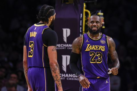 Los Angeles Lakers forward LeBron James, right, interacts with Los Angeles Lakers forward/center Anthony Davis during the second half of an Emirates NBA Cup basketball game against the Utah Jazz, Tuesday, Nov. 19, 2024, in Los Angeles. (AP Photo/Etienne Laurent)