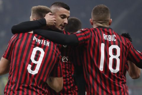 AC Milan's Krzysztof Piatek, left, celebrates after scoring his side's opening goal during an Italian Cup soccer match between AC Milan and Spal at the San Siro stadium, in Milan, Italy, Wednesday, Jan. 15, 2020. (AP Photo/Antonio Calanni)