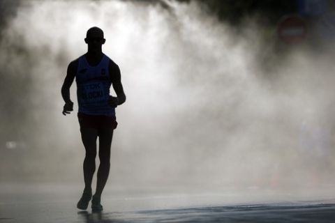 MOSCOW, RUSSIA - AUGUST 14:  An athlete competes in the Men's 50km Race Walk final during Day Five of the 14th IAAF World Athletics Championships Moscow 2013 at Luzhniki Stadium on August 14, 2013 in Moscow, Russia.  (Photo by Paul Gilham/Getty Images)