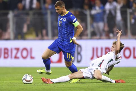 Hungary's Andras Schafer tackles Bosnia's Edin Dzeko during the Nations League soccer match between Bosnia and Hungary in Zenica, Bosnia and Herzegovina, on Monday, Oct. 14, 2024. (AP Photo/Armin Durgut)